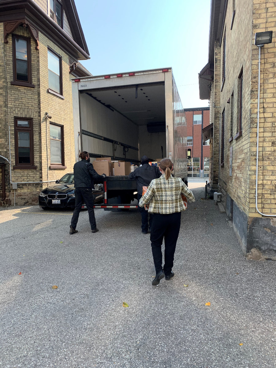 Members of GGFI loading boxes of food onto a truck.